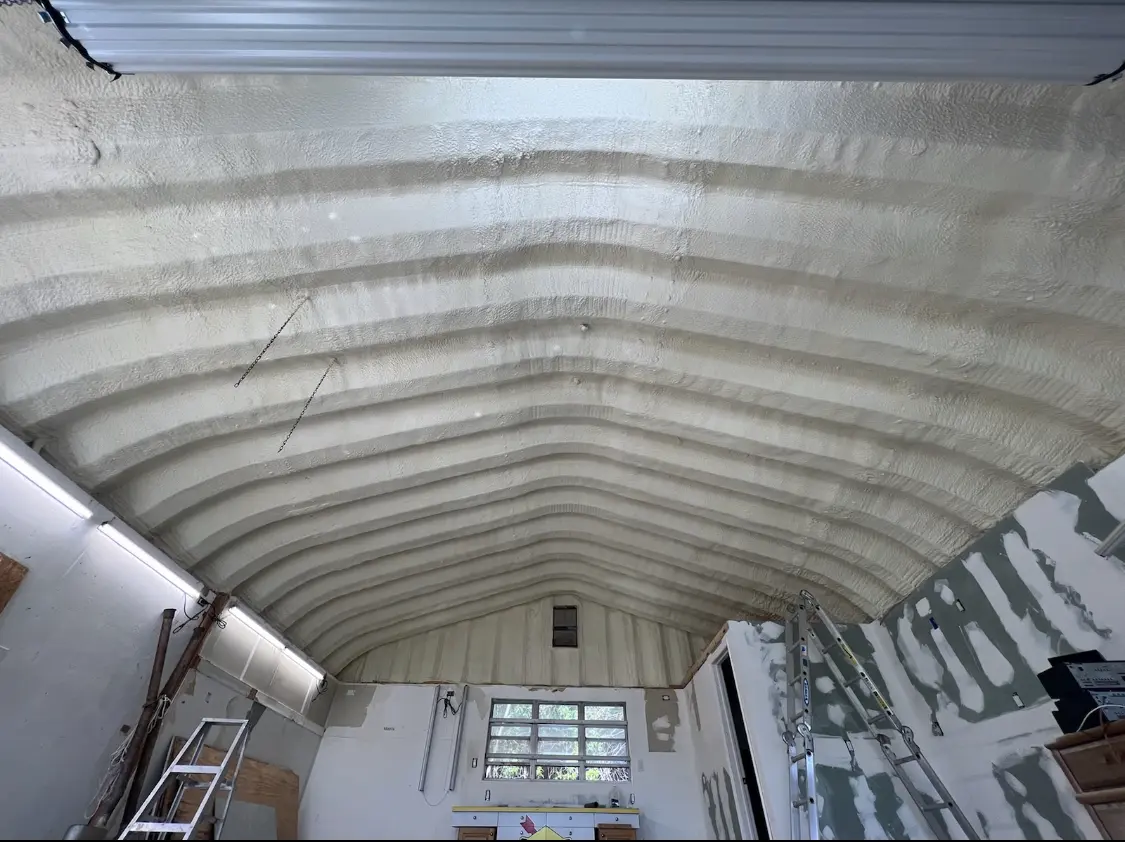 Spray polyurethane foam applied to the underside of a metal roof deck in Durham